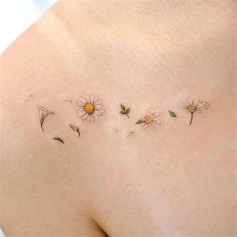 22 A Tattoo Of Daisies Lilies And Petals Daisy Tattoo Designs