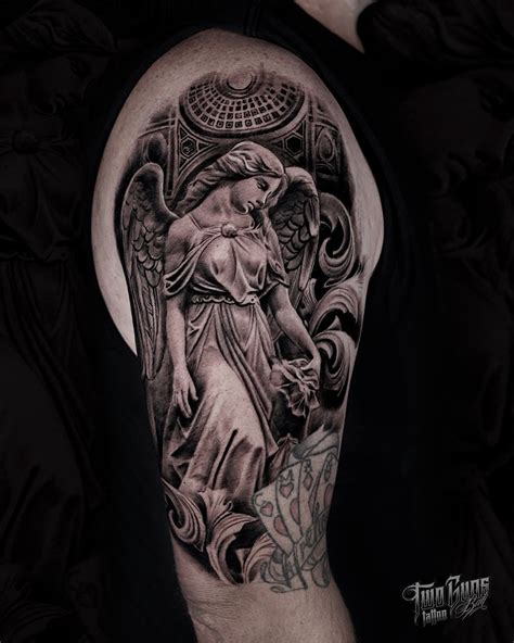 A Beautiful Angel Statue Upper Arm Realistic Black And Grey Tattoo Art By Pank Bali S Premium Tattoo Studio New Zealand Owned Operated World Class Award Winning Artists