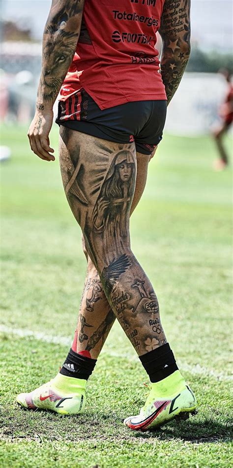 A Man With Tattoos On His Legs Standing In The Grass A Man With Tattoos On His Legs Standing In The Grass