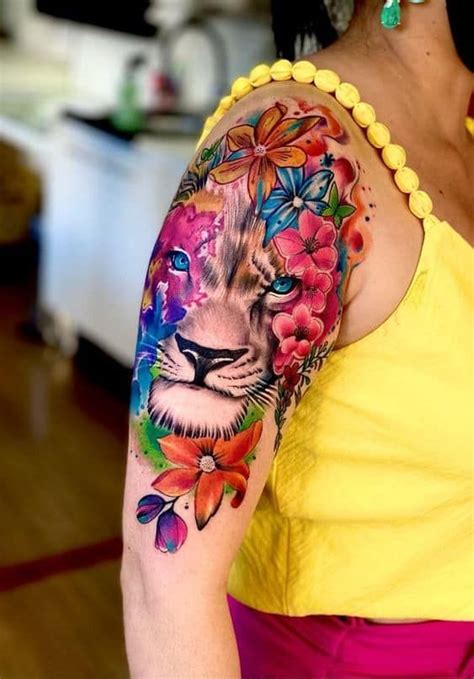 A Woman Amp 39 S Arm With A Colorful Tattoo Design On Her Left Arm And The A Woman Amp 39 S Arm With A Colorful Tattoo Design On Her Left Arm And The