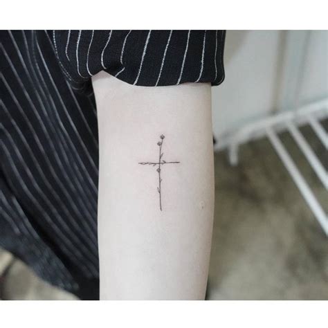 Fine Line Style Flower Cross Tattoo Located On The