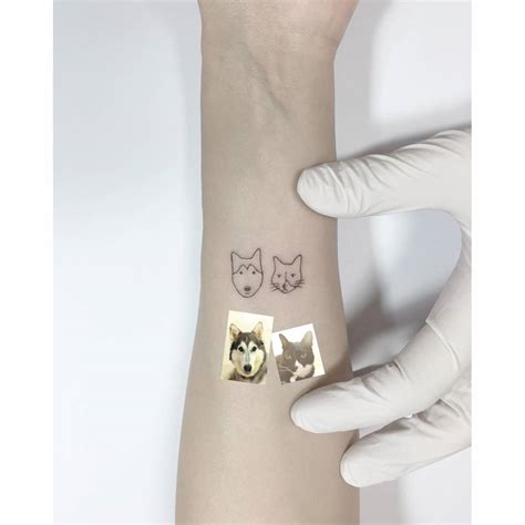 Minimalistic Dog And Cat Portrait Tattoo Located On The