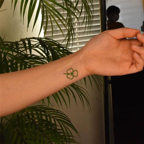 Minimalistic Four Leaf Clover Tattoo On The Wrist Minimalistic Four Leaf Clover Tattoo On The Wrist